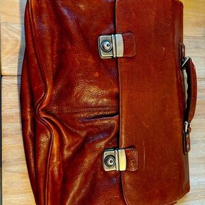 Wilson's Brown leather briefcase. Interior does have some wear and tear.